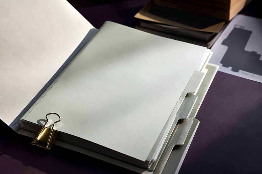 Indexed folders, document tabs, and a clean checklist arranged on a work surface